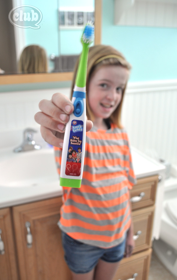 Tween with One Direction Tooth Tunes toothbrush