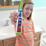 Tween with One Direction Tooth Tunes toothbrush